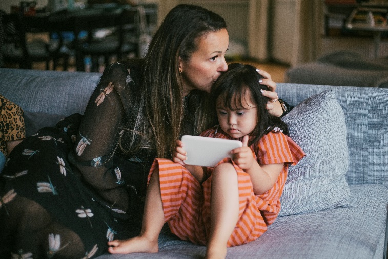 A mom kisses her child's head.