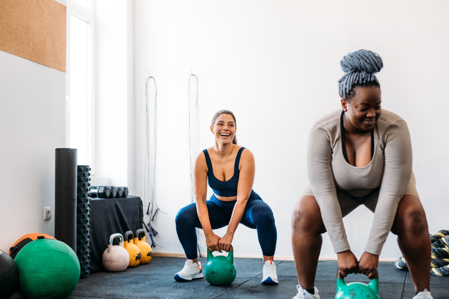 Two ladies working out with weights.